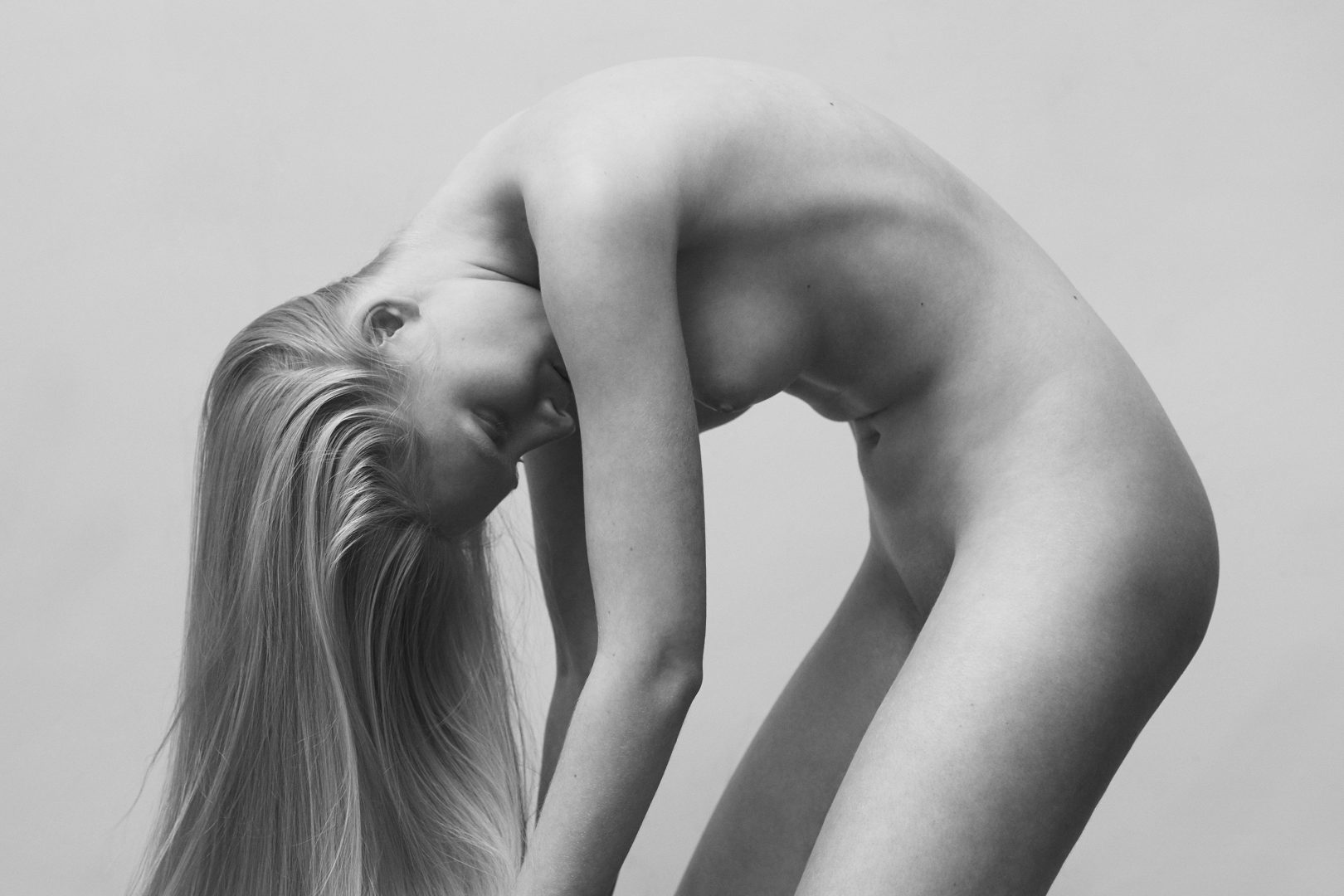 Naked girl bending forward by Stefan Rappo