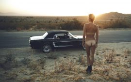 Thumbnail Naked girl watching sunset with Ford mustang by Stefan Rappo