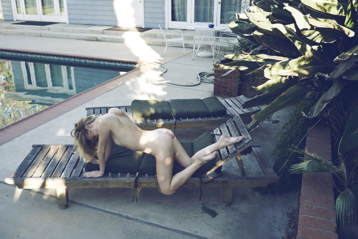 Naked girl on a long chair by pool by Stefan Rappo
