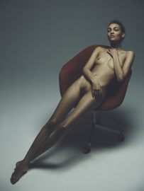 Thumbnail Girl sitting naked on chair by Stefan Rappo