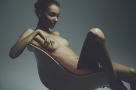 Thumbnail Girl sitting naked on chair by Stefan Rappo