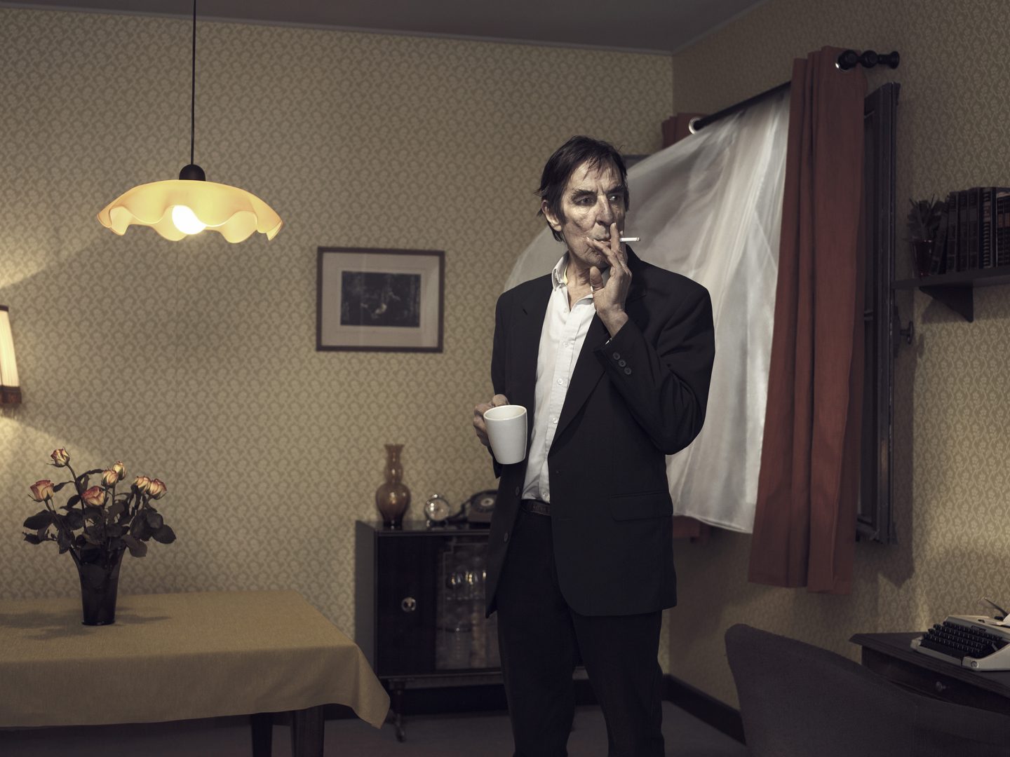 Smoking man is standing in room 42 with open window by Stefan Rappo