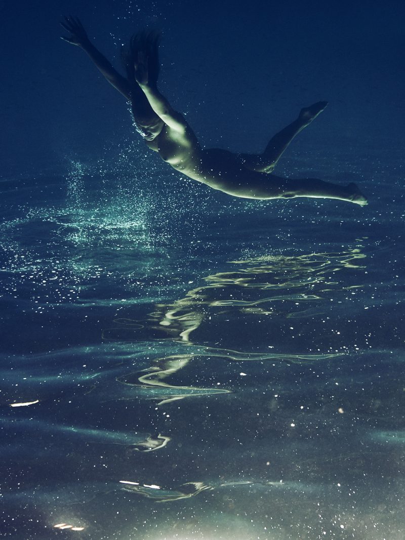 Naked girl under water in sea by Stefan Rappo