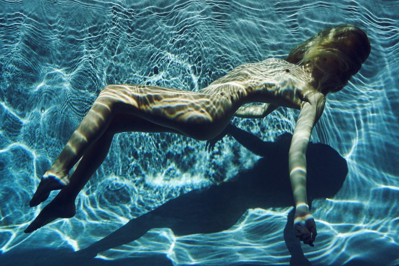 naked girl in underwater in swimming pool by stefan rappo