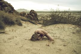 Thumbnail Naked girl on the floor in the desert by Stefan Rappo