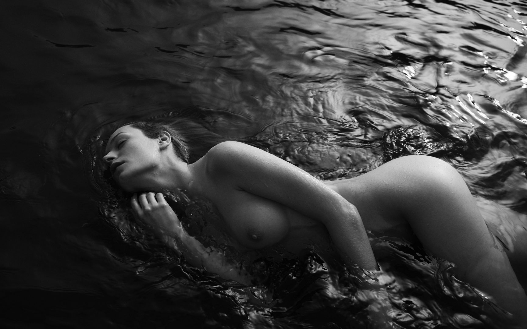 Naked girl merging in water by Stefan Rappo
