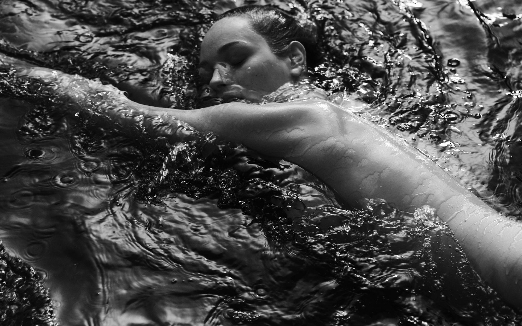Naked girl merging in water by Stefan Rappo