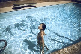 Thumbnail Girl standing naked in swimming pool by Stefan Rappo