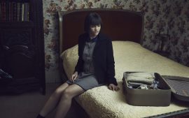 Thumbnail Girl sitting on bed and unpacking her suitcase by Stefan Rappo