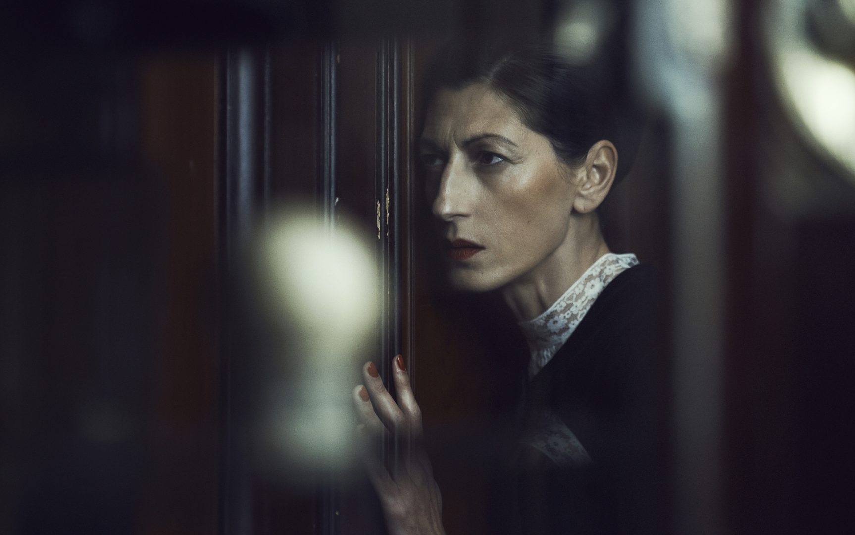 Women listen to conversation at door by Stefan Rappo