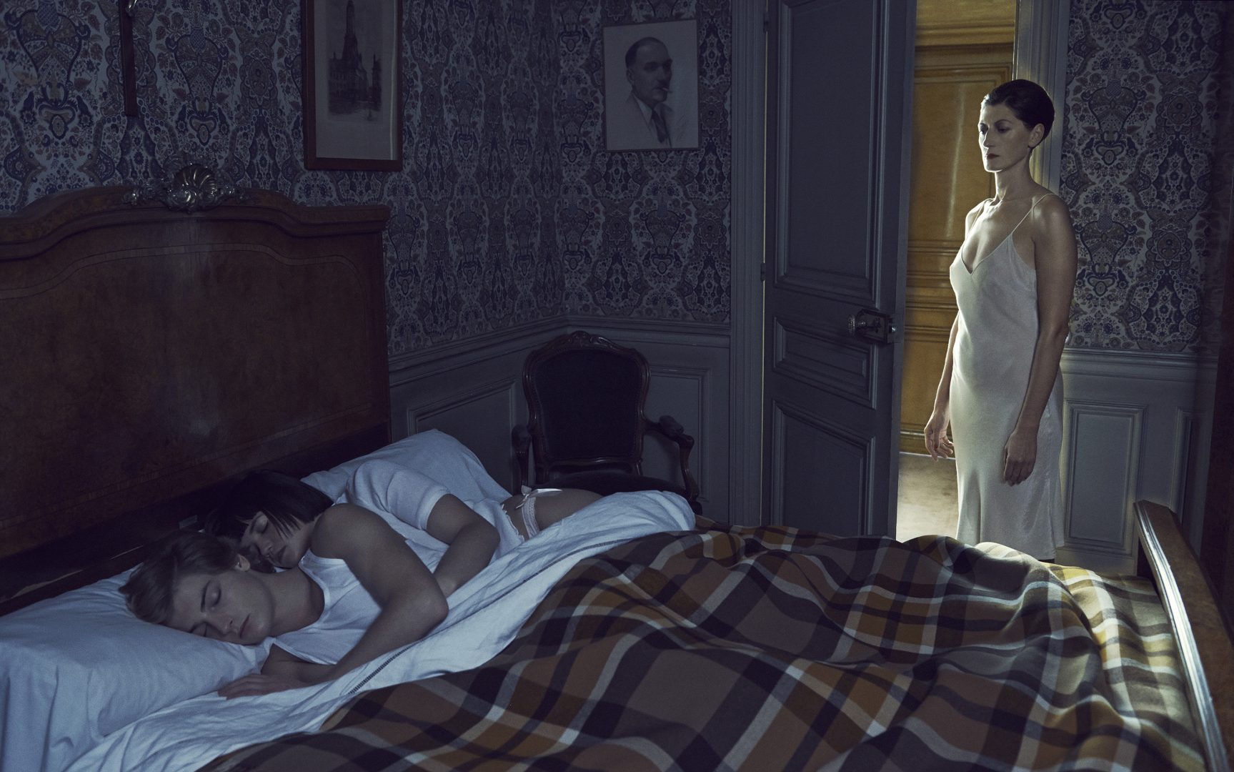 Couple of boy and girl sleeping in bed and being watched by women by Stefan Rappo
