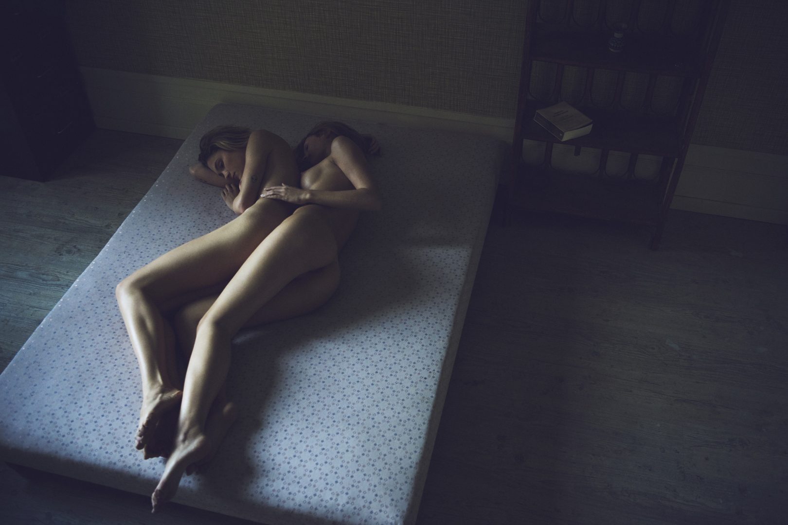 2 naked girls lying together on mattress by Stefan Rappo