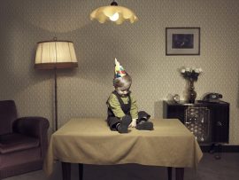 Thumbnail Kid sitting on table in room 42 by Stefan Rappo