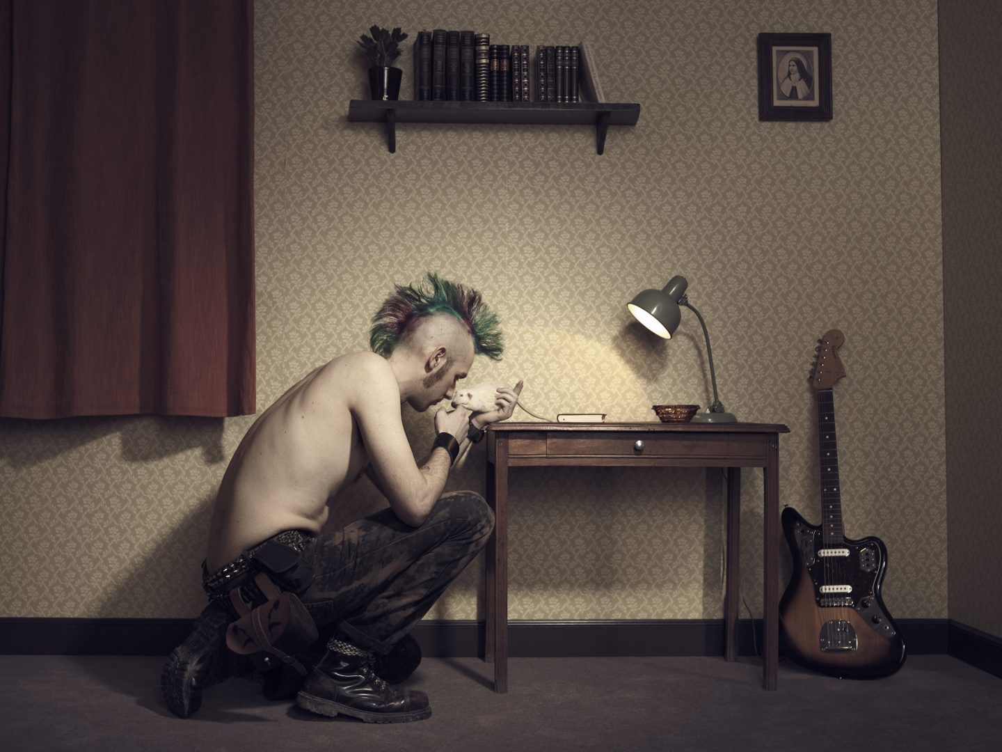 Punk playing with his rat in room 42 by Stefan Rappo