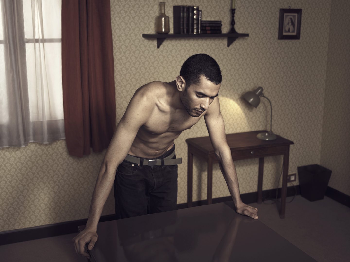 Man leaning on table in room 42 by Stefan Rappo
