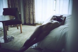 Thumbnail Naked black girl lying on bed in hotel room by Stefan Rappo