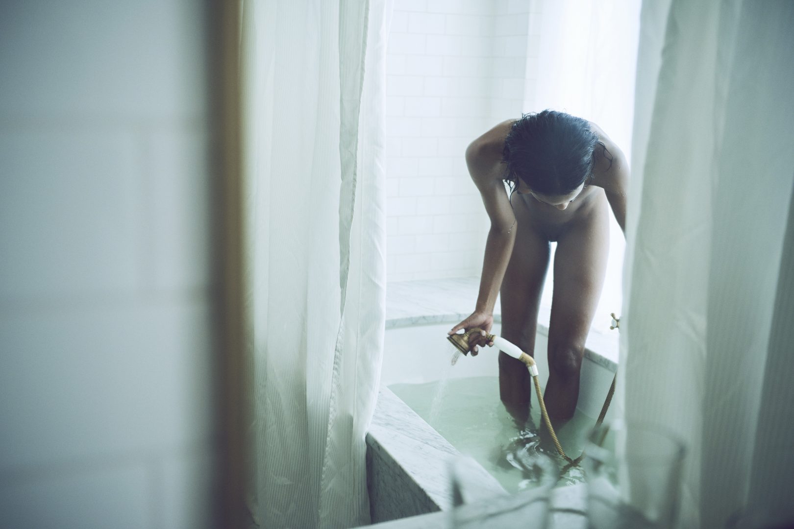 Naked black girl filling up bathtub by Stefan Rappo